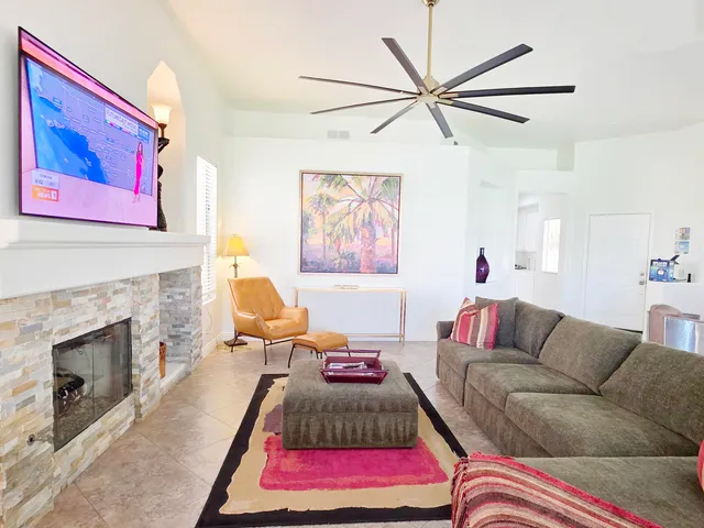 a living room with furniture and a fireplace