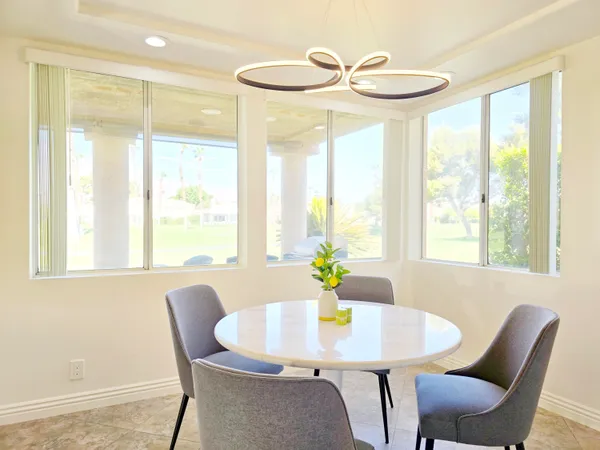 a view of a dining room with furniture and a window