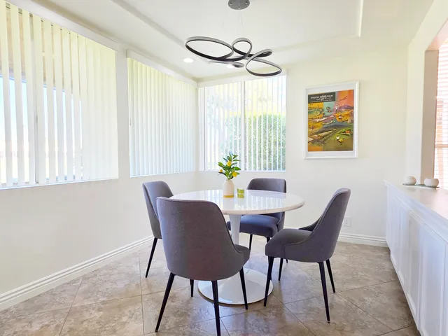 a view of a dining room with furniture and window