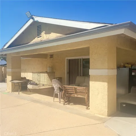 a view of a patio with table and chairs