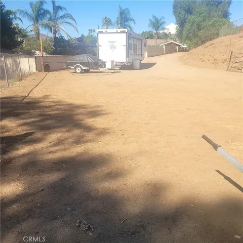 a view of a backyard of snow and trees
