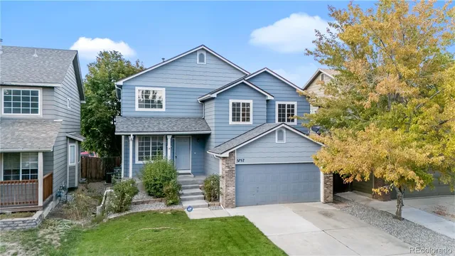 a front view of a house with a garden and yard