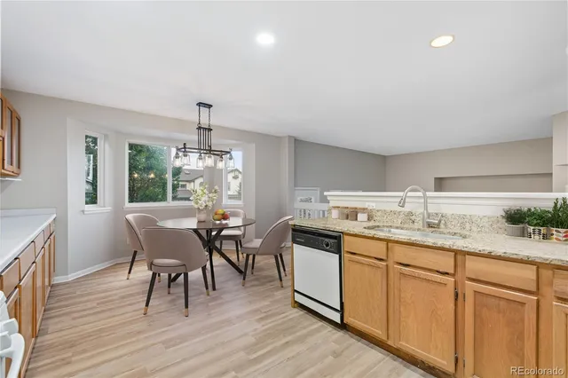 a kitchen with granite countertop sink dining table and chairs