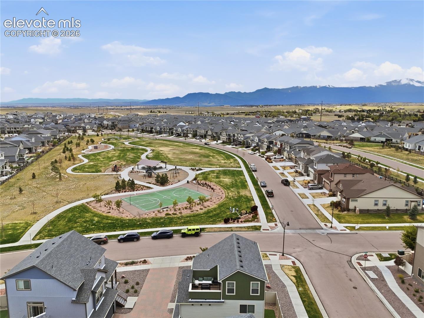 6008 Ashmore Road Colorado Springs, CO 80927 - Photo 48 of 48 Expansive community greenspace with a basketball court, walking paths, and mountain scenery