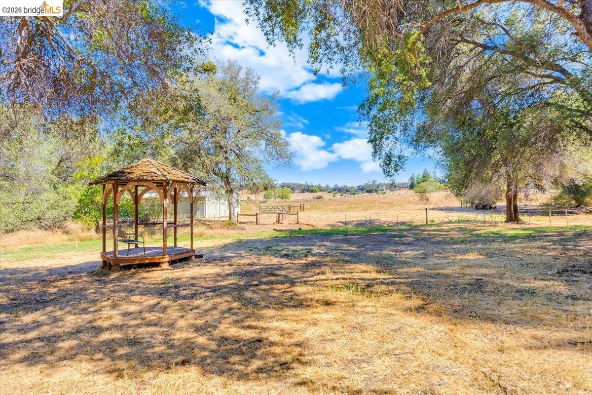 8733 Fraguero Road Sonora, CA 95370 - Photo 66 of 73 Wood gazebo with shingled roof and open sides