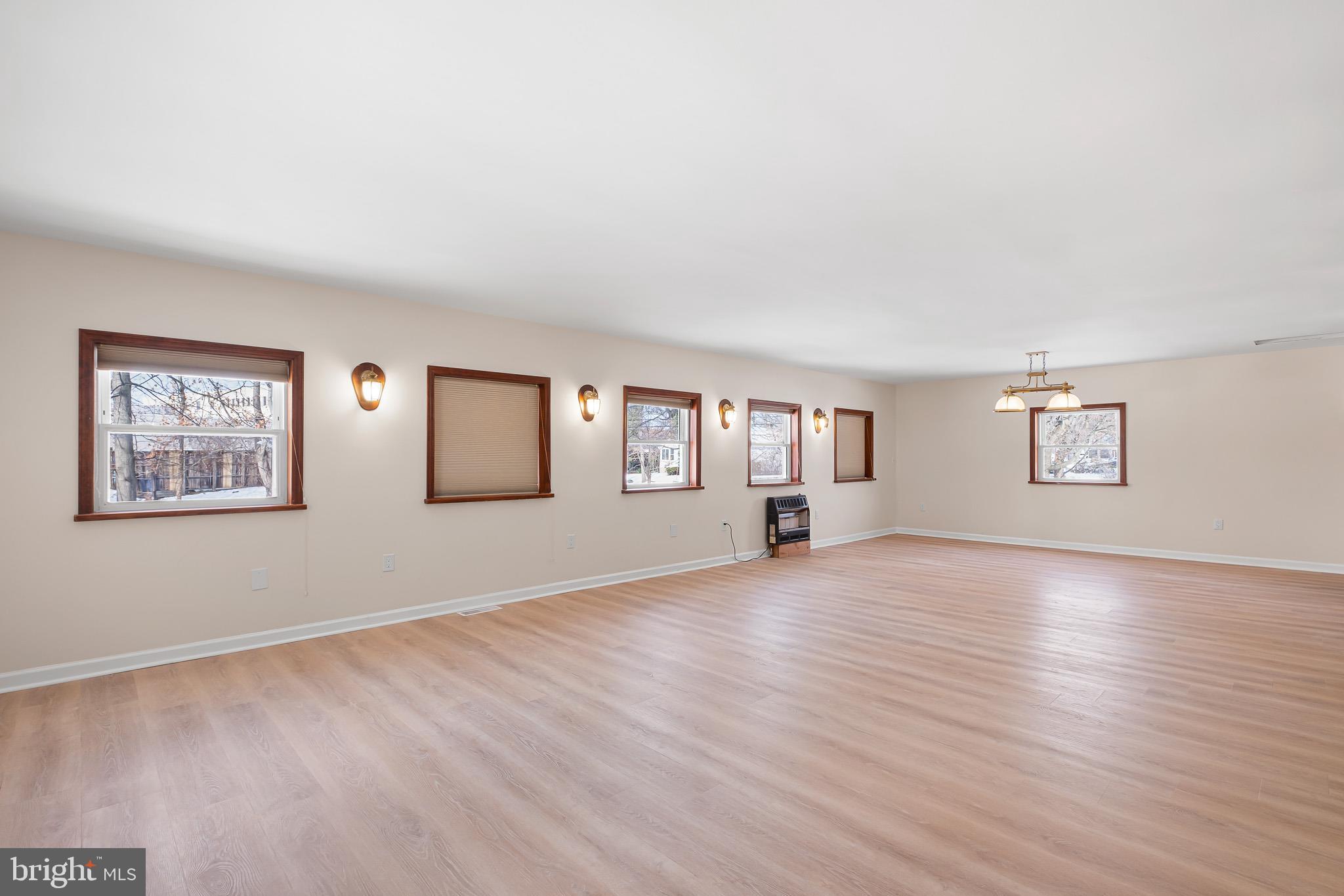 2920 Cheshire Road Wilmington, DE 19810 - Photo 12 of 34 a view of an empty room with a window and wooden floor