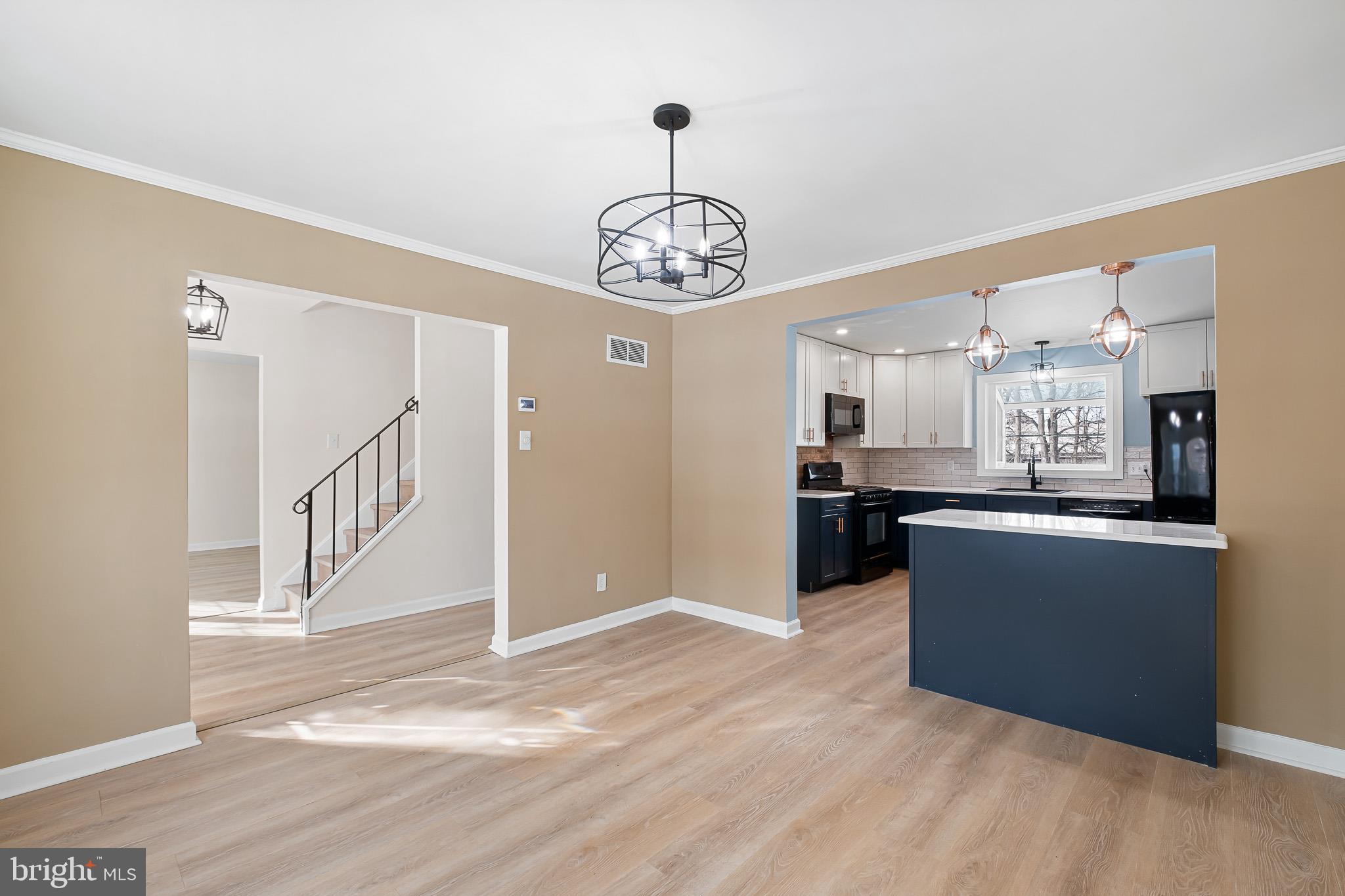 2920 Cheshire Road Wilmington, DE 19810 - Photo 8 of 34 a view of a kitchen with kitchen island wooden floor stainless steel appliances and cabinets