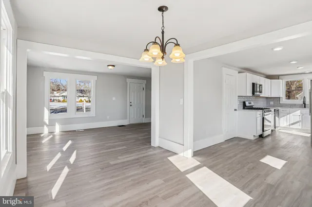 a kitchen with stainless steel appliances a refrigerator and a stove top oven
