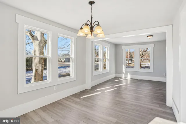 a kitchen with stainless steel appliances a refrigerator and wooden floor
