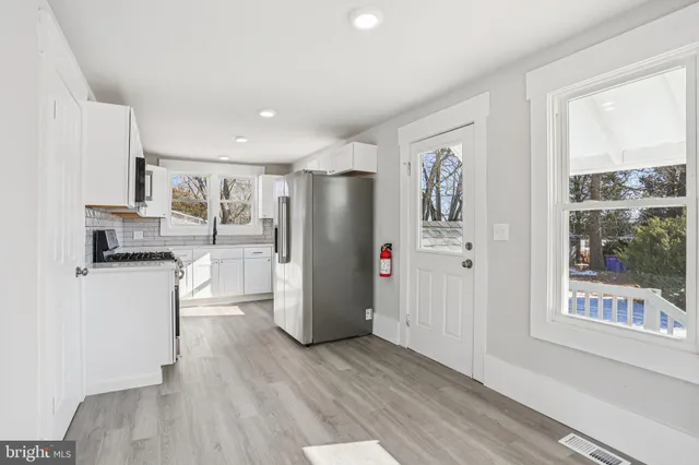a kitchen with stainless steel appliances granite countertop a sink stove and microwave