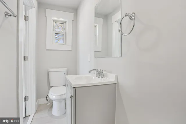 a bathroom with a sink a mirror and a lamp