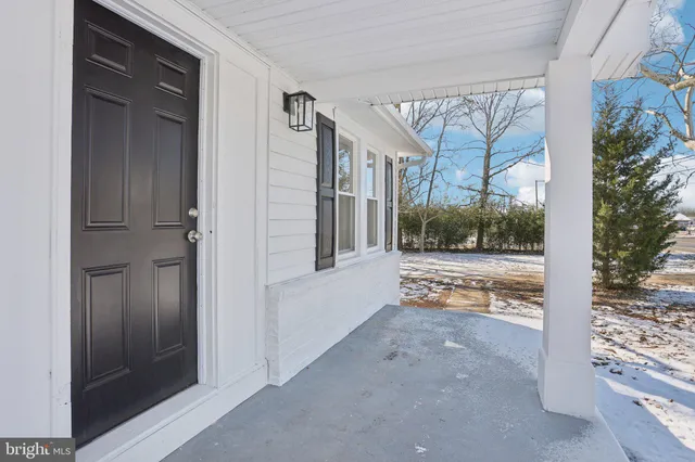 a view of an entryway with wooden floor and stairs