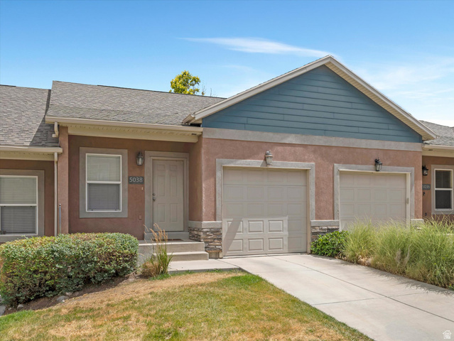 5038 West Red Shale Road Herriman, UT 84096 - Photo 2 of 16 Exterior featuring a light tan stucco facade with stone accents, a blue horizontal siding gable, dual garage doors, and a front entry with a light-colored door