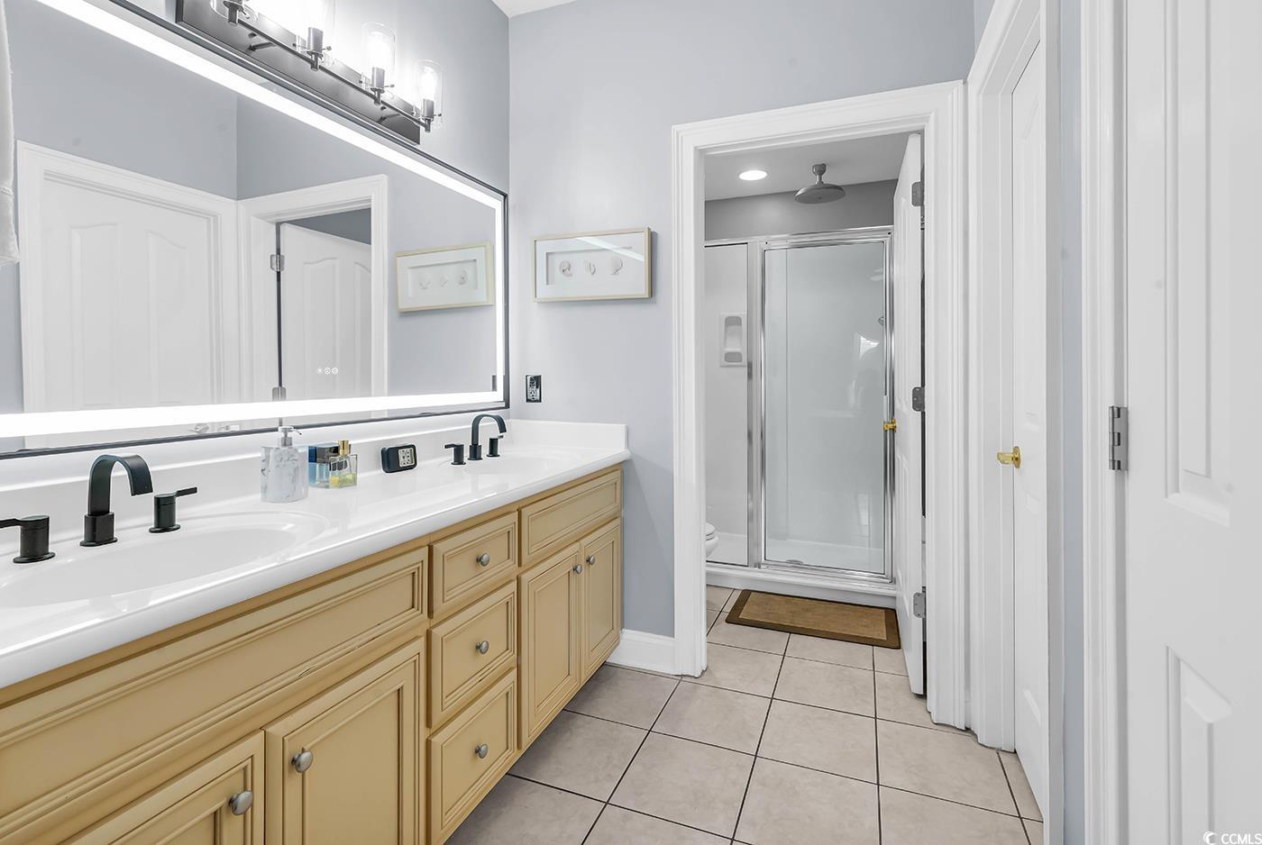 1459 St Thomas Circle, Unit F2 Myrtle Beach, SC 29577 - Photo 13 of 31 Full bath featuring a shower stall, light tile patterned floors, and double vanity