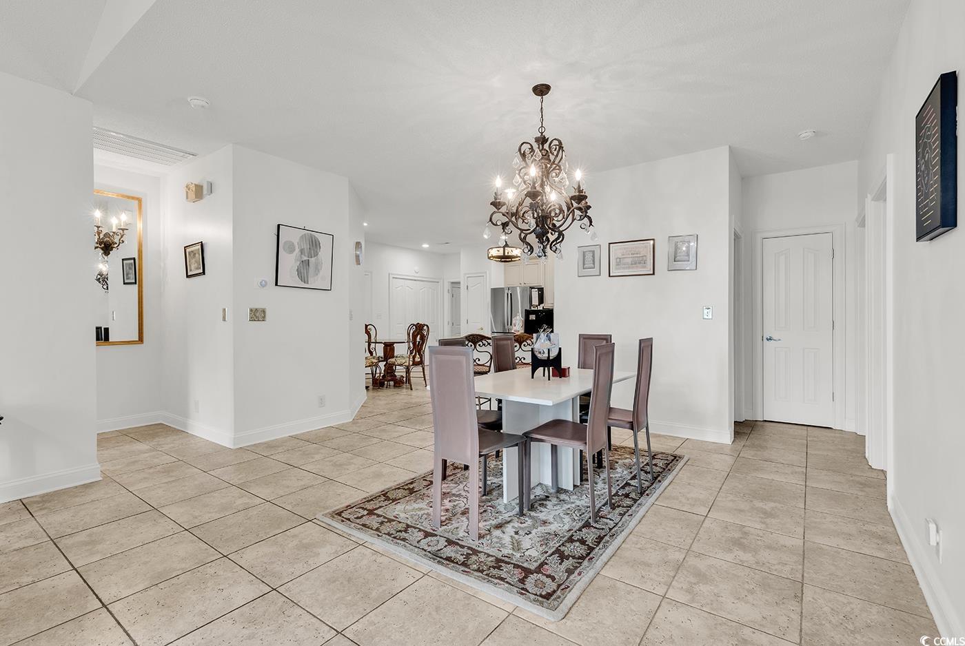 1459 St Thomas Circle, Unit F2 Myrtle Beach, SC 29577 - Photo 7 of 31 Dining room with a chandelier and tile floors