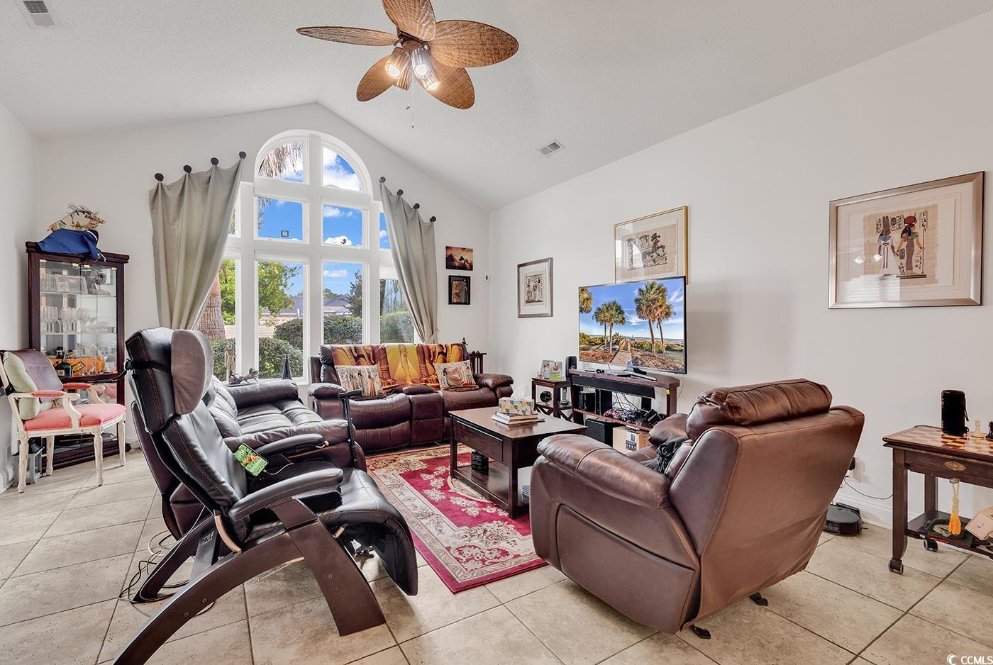 1459 St Thomas Circle, Unit F2 Myrtle Beach, SC 29577 - Photo 8 of 31 Living area featuring a ceiling fan, high vaulted ceiling, and tile flooring