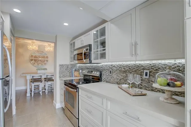 a kitchen with stainless steel appliances a stove a sink and a microwave