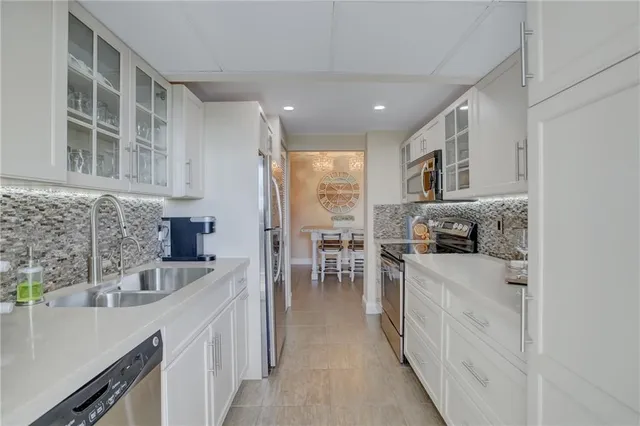 a kitchen with sink stove and cabinets