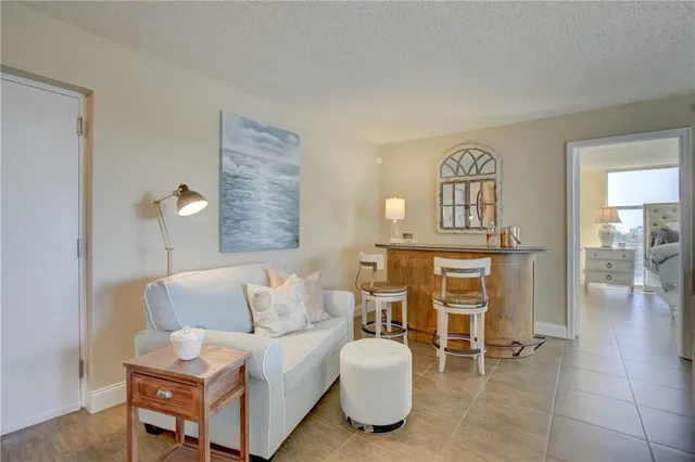 a living room with furniture a dining table and a fireplace