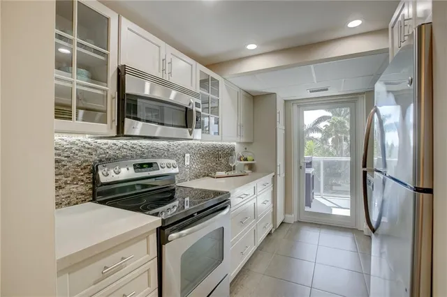 a kitchen with stainless steel appliances granite countertop a stove and a refrigerator