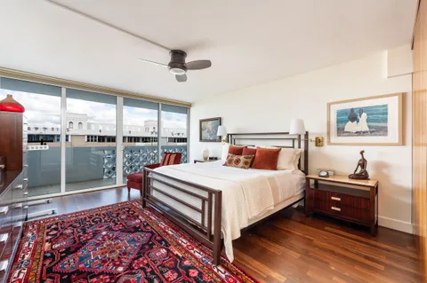 a living room with furniture and paintings on the wall