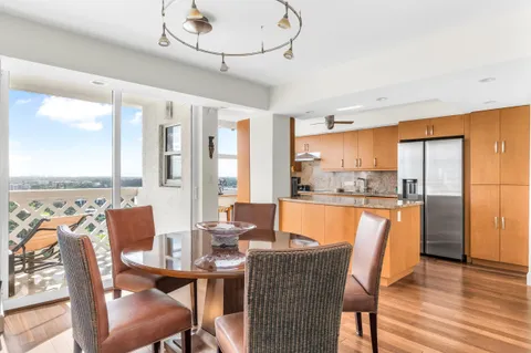 a kitchen with stainless steel appliances granite countertop a sink a stove and a wooden floors
