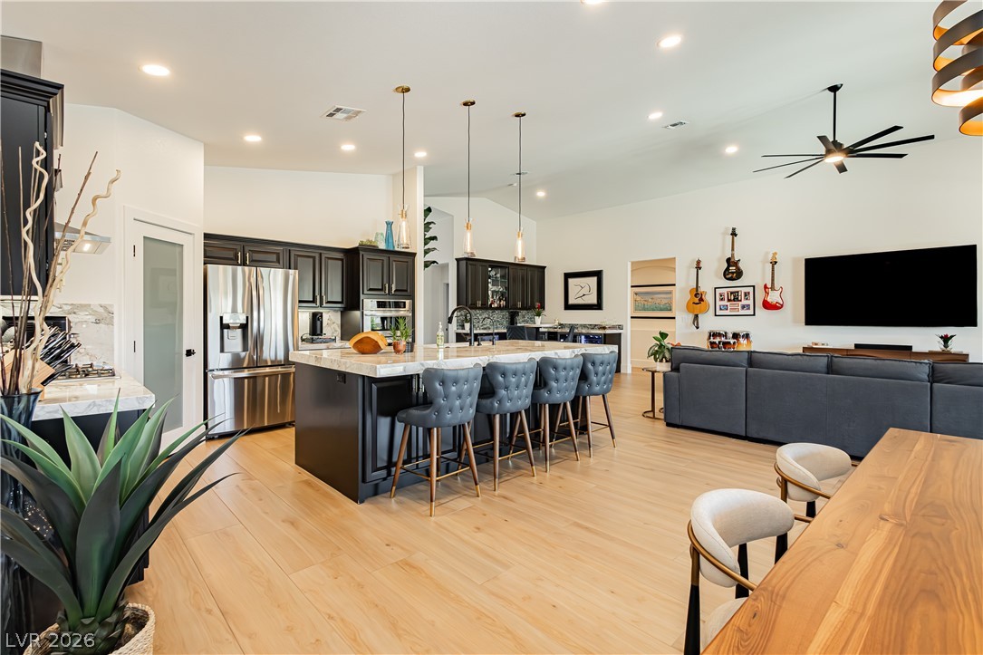 2256 Dogwood Ranch Avenue Henderson, NV 89052 - Photo 17 of 51 An open-concept living space with a gourmet kitchen, an inviting dining area, and a large living room.