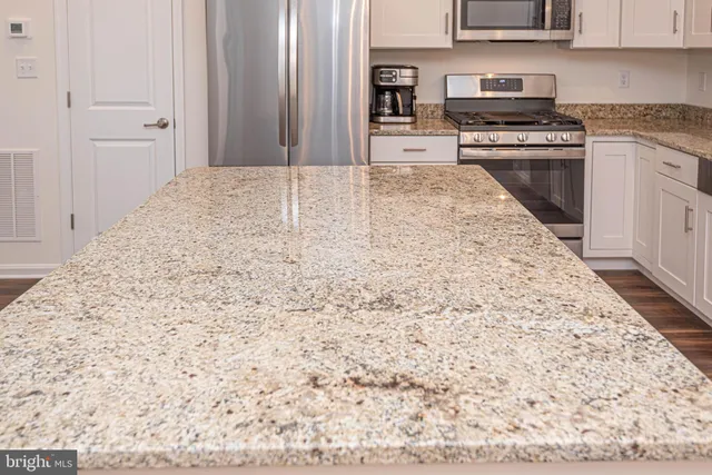 a view of a hallway with wooden floor and windows