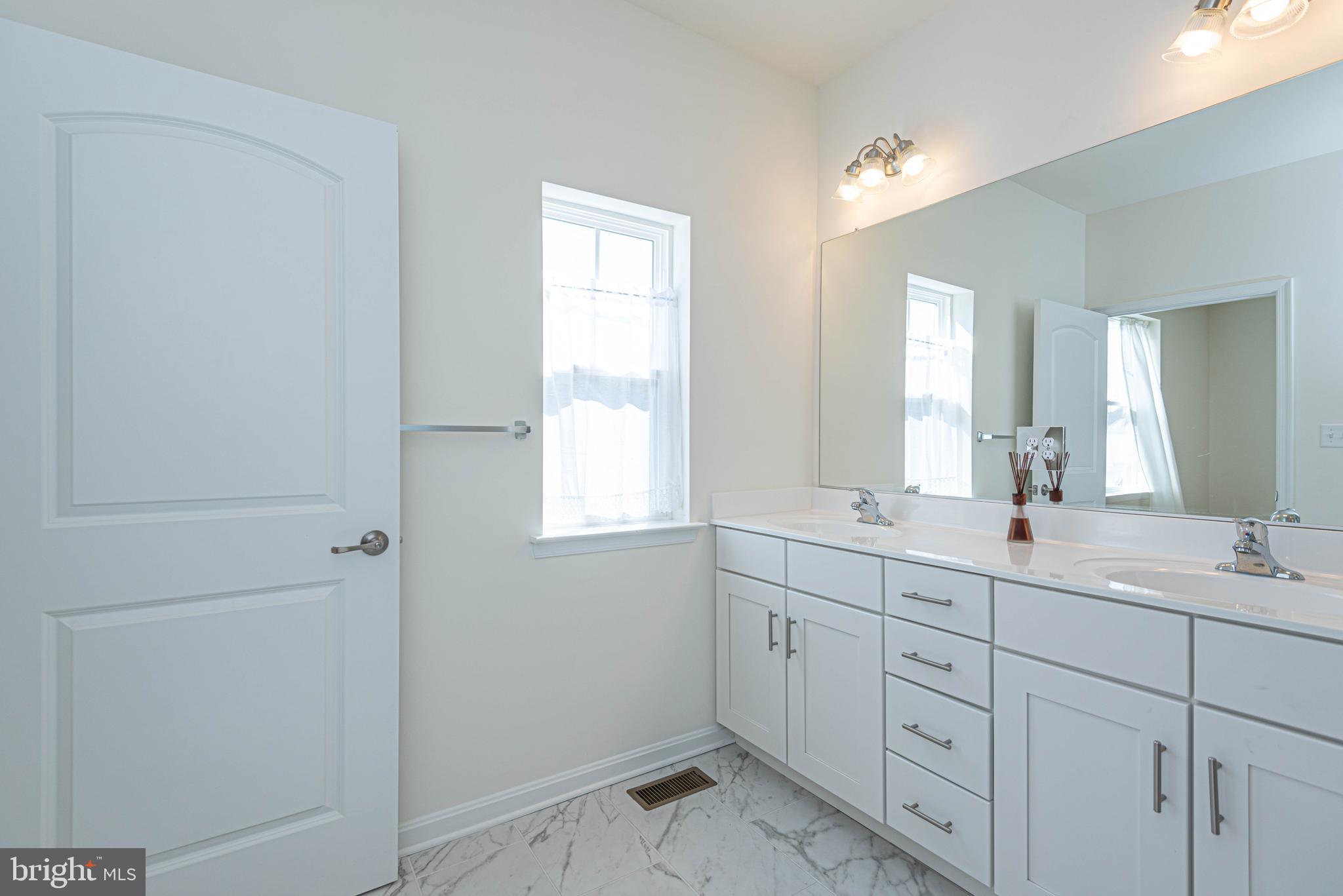 211 Prospect Street Milton, DE 19968 - Photo 34 of 64 a bathroom with 2 sink tub and a mirror
