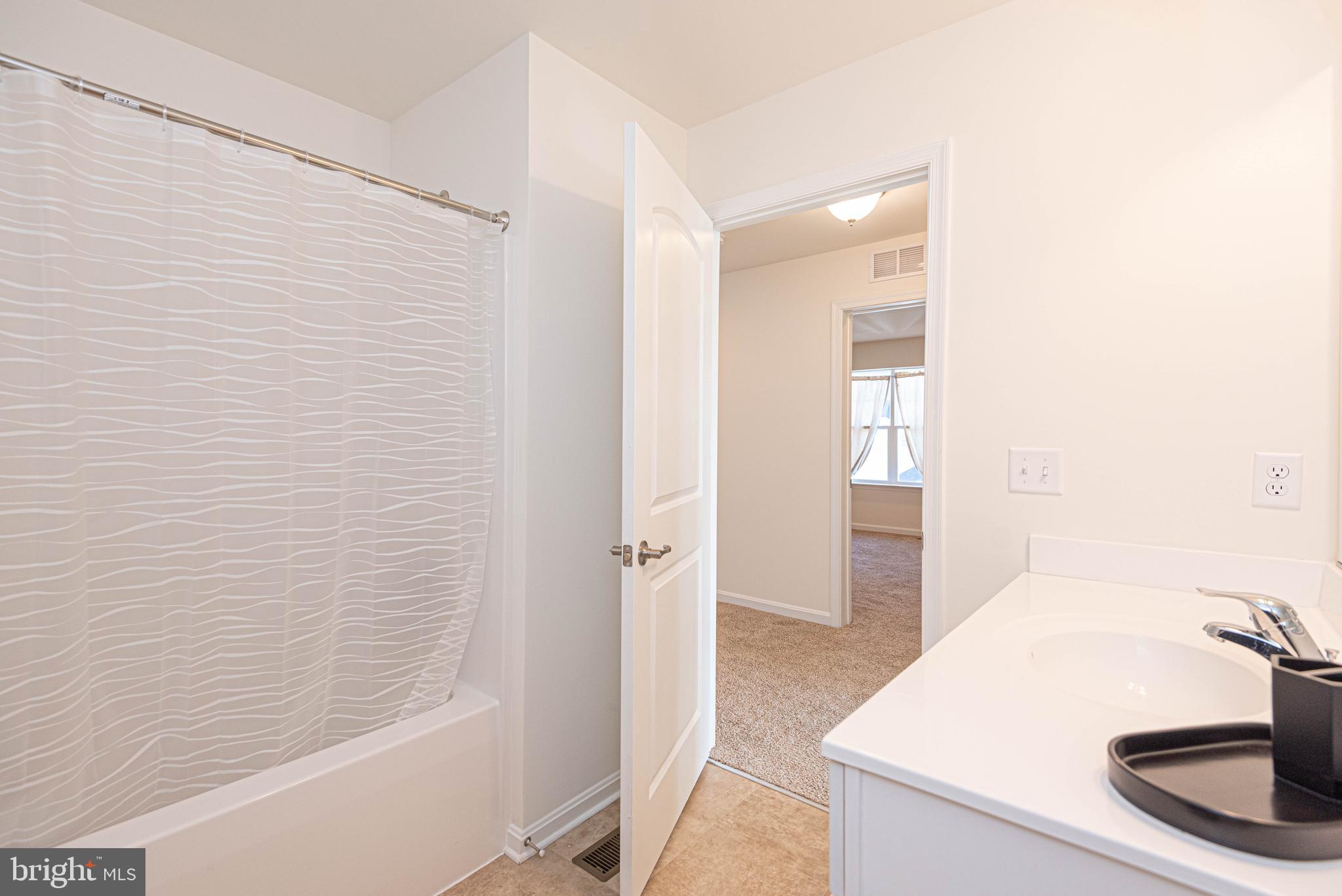 211 Prospect Street Milton, DE 19968 - Photo 46 of 64 a bathroom with a sink and a shower