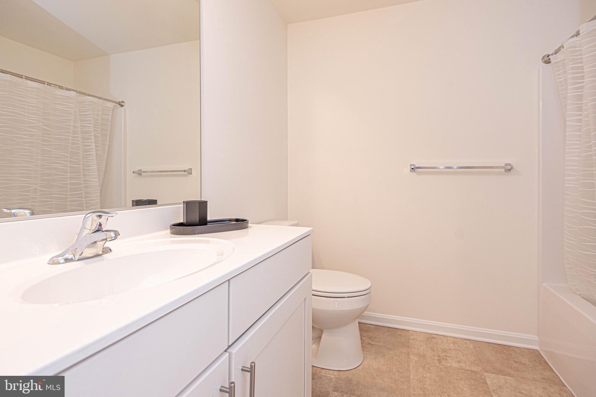 211 Prospect Street Milton, DE 19968 - Photo 47 of 64 a bathroom with a sink a toilet and a mirror