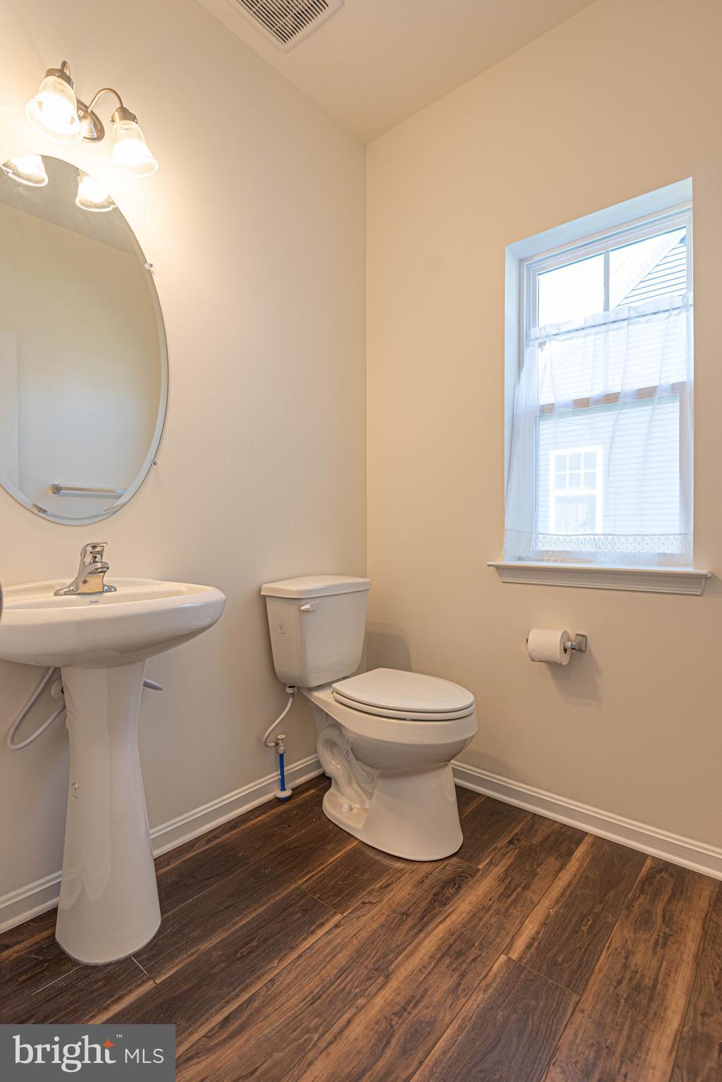 211 Prospect Street Milton, DE 19968 - Photo 53 of 64 a bathroom with a sink toilet and a mirror