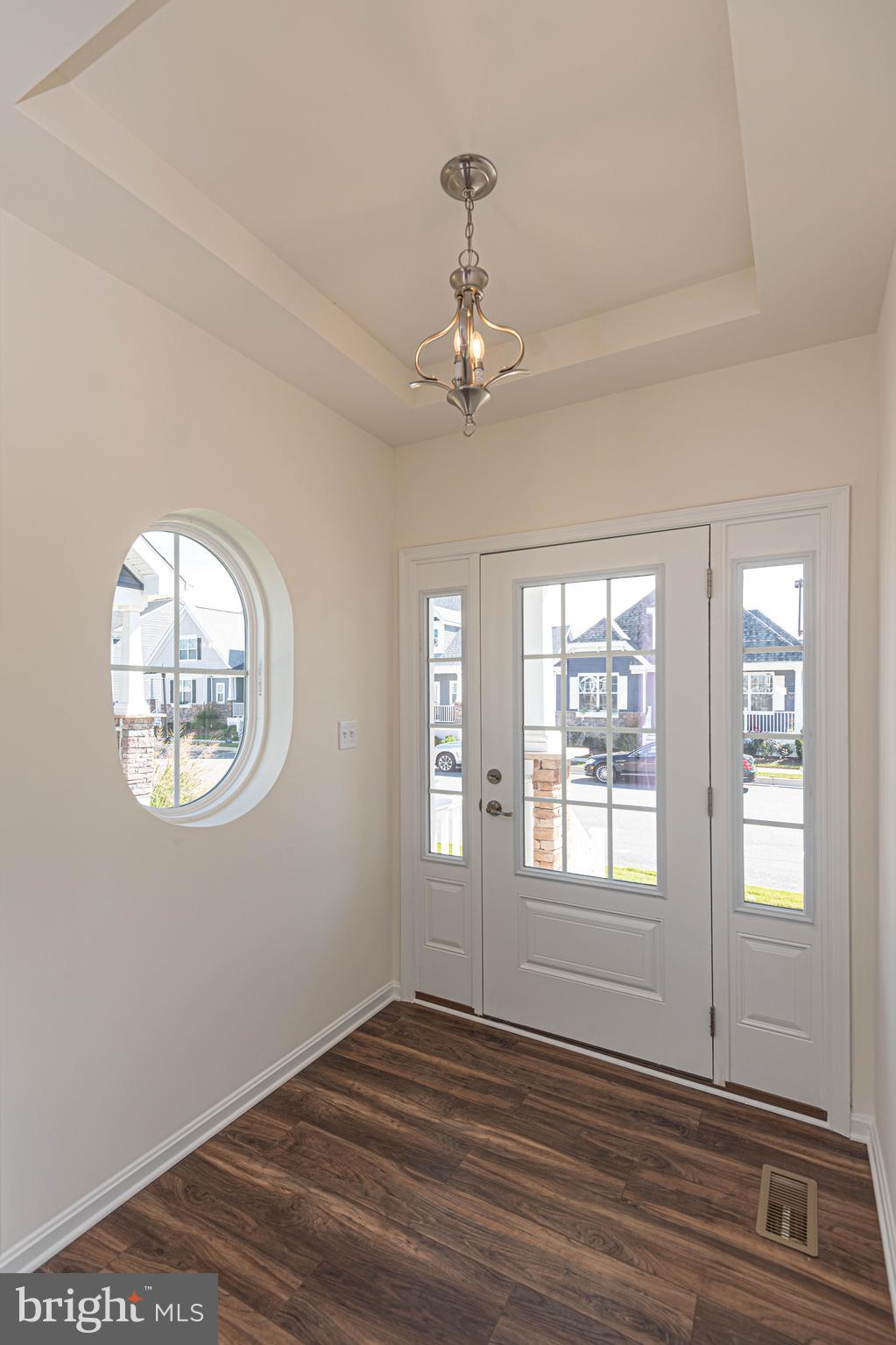211 Prospect Street Milton, DE 19968 - Photo 8 of 64 a view of an empty room with wooden floor and a window