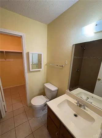 a bathroom with a sink and mirror with toilet