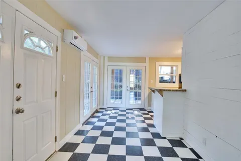 a view of a big room with windows and chandelier