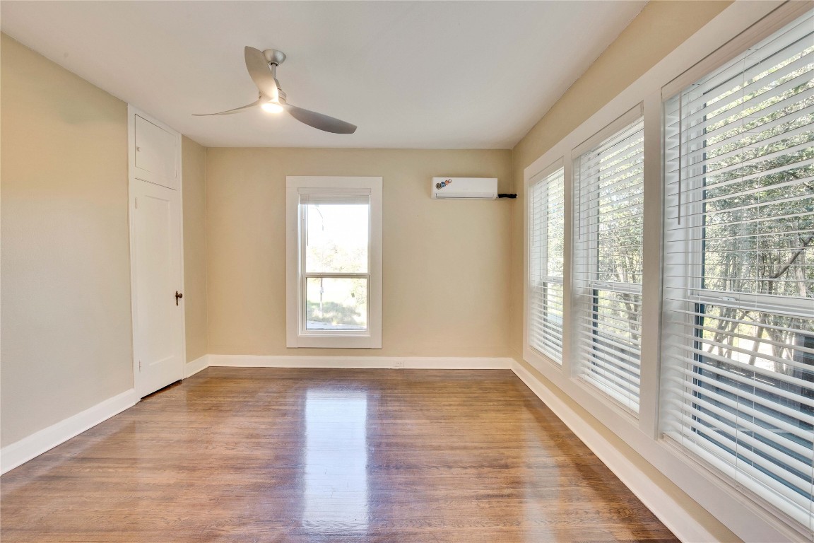 1115 Enfield Road, Unit A Austin, TX 78703 - Photo 13 of 21 a view of an empty room with wooden floor and a window