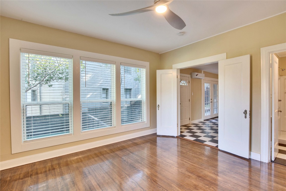 1115 Enfield Road, Unit A Austin, TX 78703 - Photo 16 of 21 a view of an empty room with wooden floor and a window