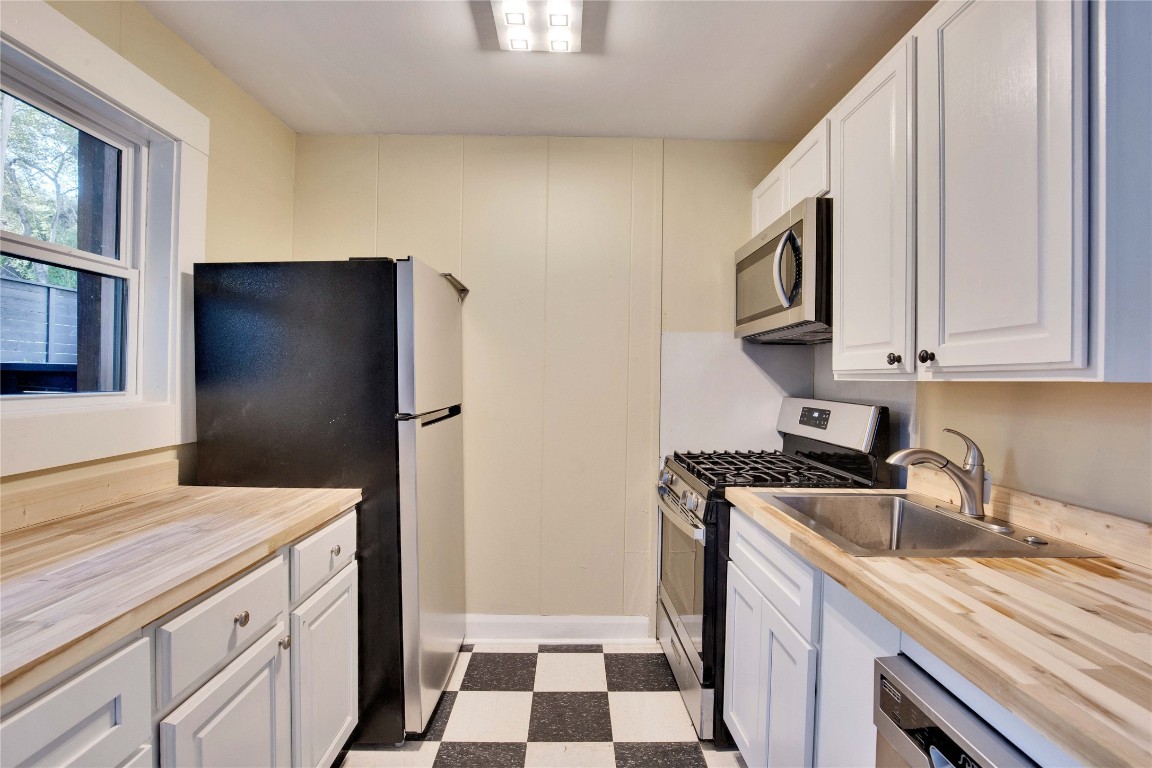 1115 Enfield Road, Unit A Austin, TX 78703 - Photo 7 of 21 a kitchen with stainless steel appliances granite countertop a refrigerator and a sink