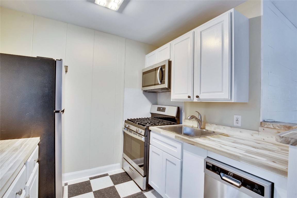 1115 Enfield Road, Unit A Austin, TX 78703 - Photo 8 of 21 a kitchen with stainless steel appliances granite countertop a stove a sink and a refrigerator