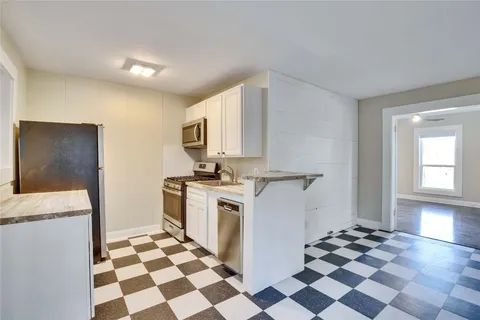 a view of a big room with windows and mirror