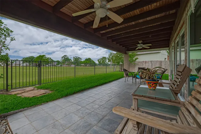 a view of a porch with furniture and garden