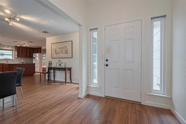 a view of kitchen with furniture and wooden floor