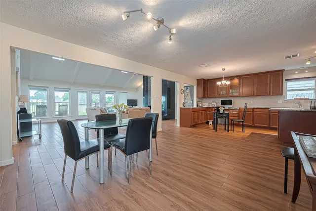 a view of a dining room with furniture and wooden floor