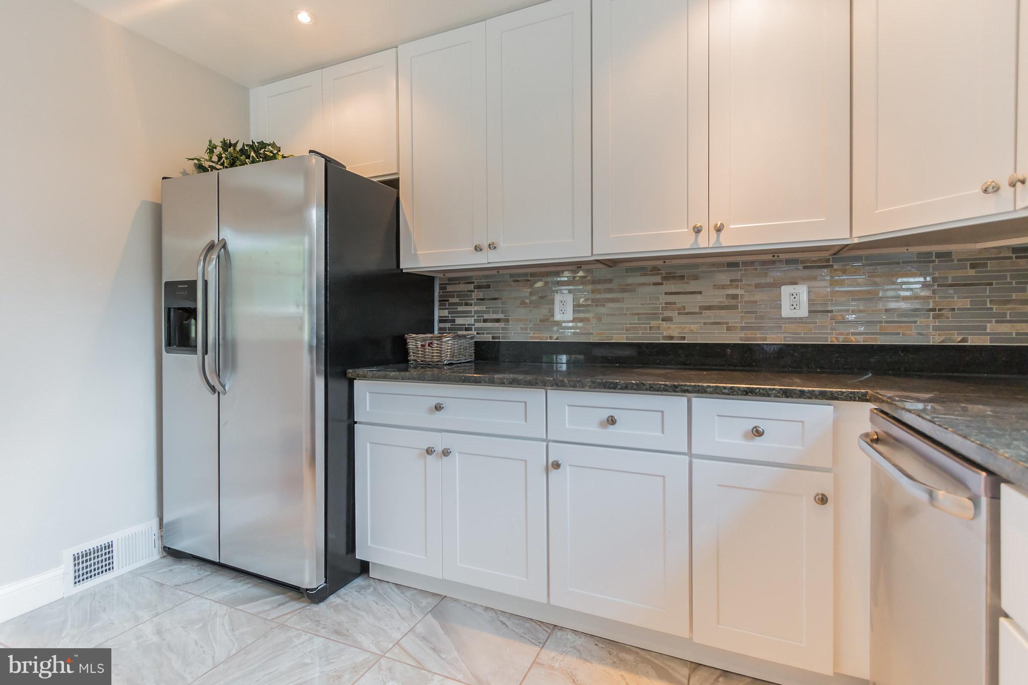 11508 Veirs Mill Road Silver Spring, MD 20902 - Photo 11 of 30 a kitchen with appliances cabinets and a counter top space