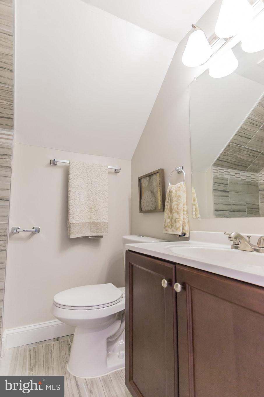 11508 Veirs Mill Road Silver Spring, MD 20902 - Photo 21 of 30 a bathroom with a toilet sink and mirror