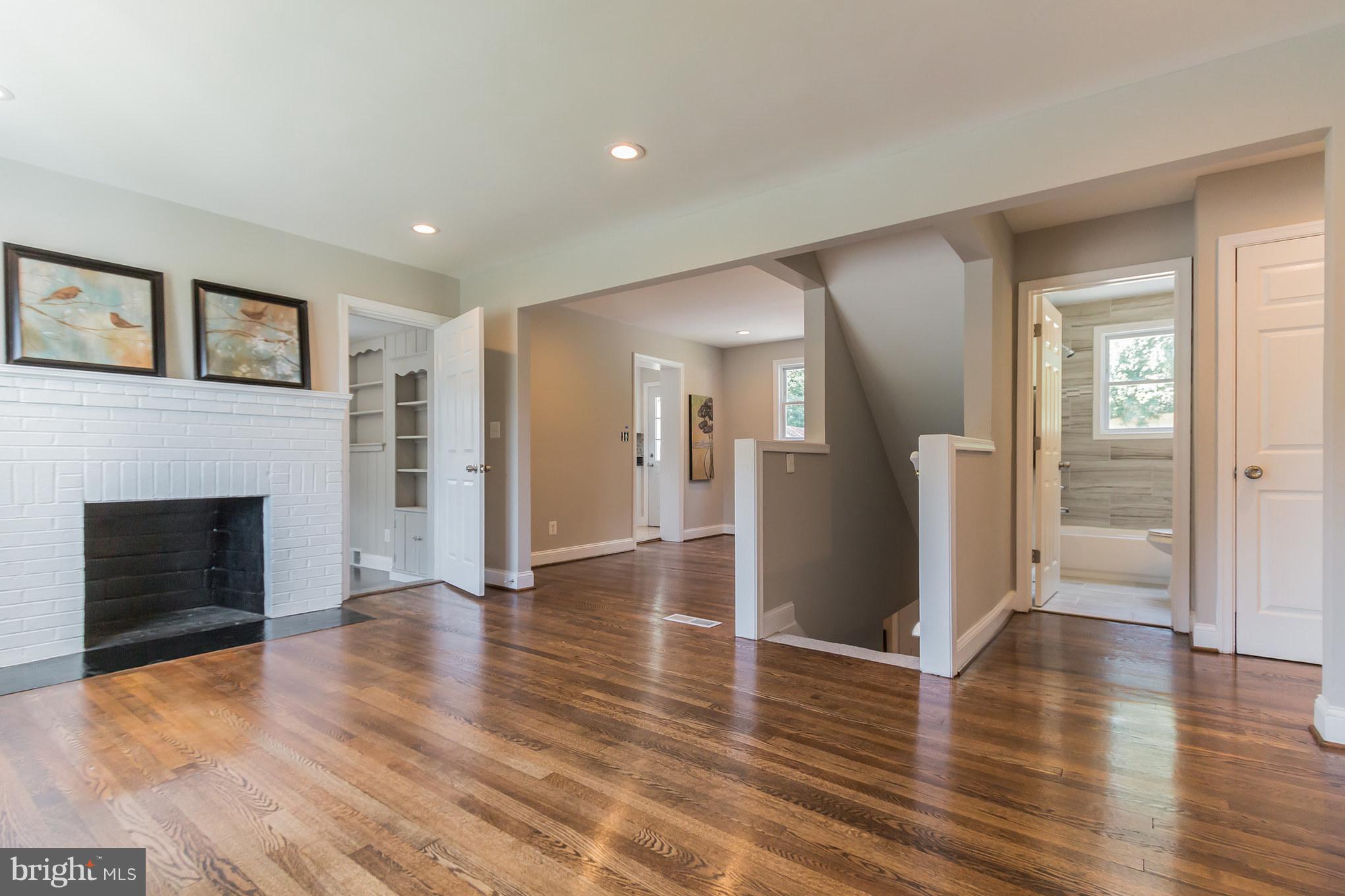 11508 Veirs Mill Road Silver Spring, MD 20902 - Photo 4 of 30 a view of a livingroom with wooden floor and a fireplace