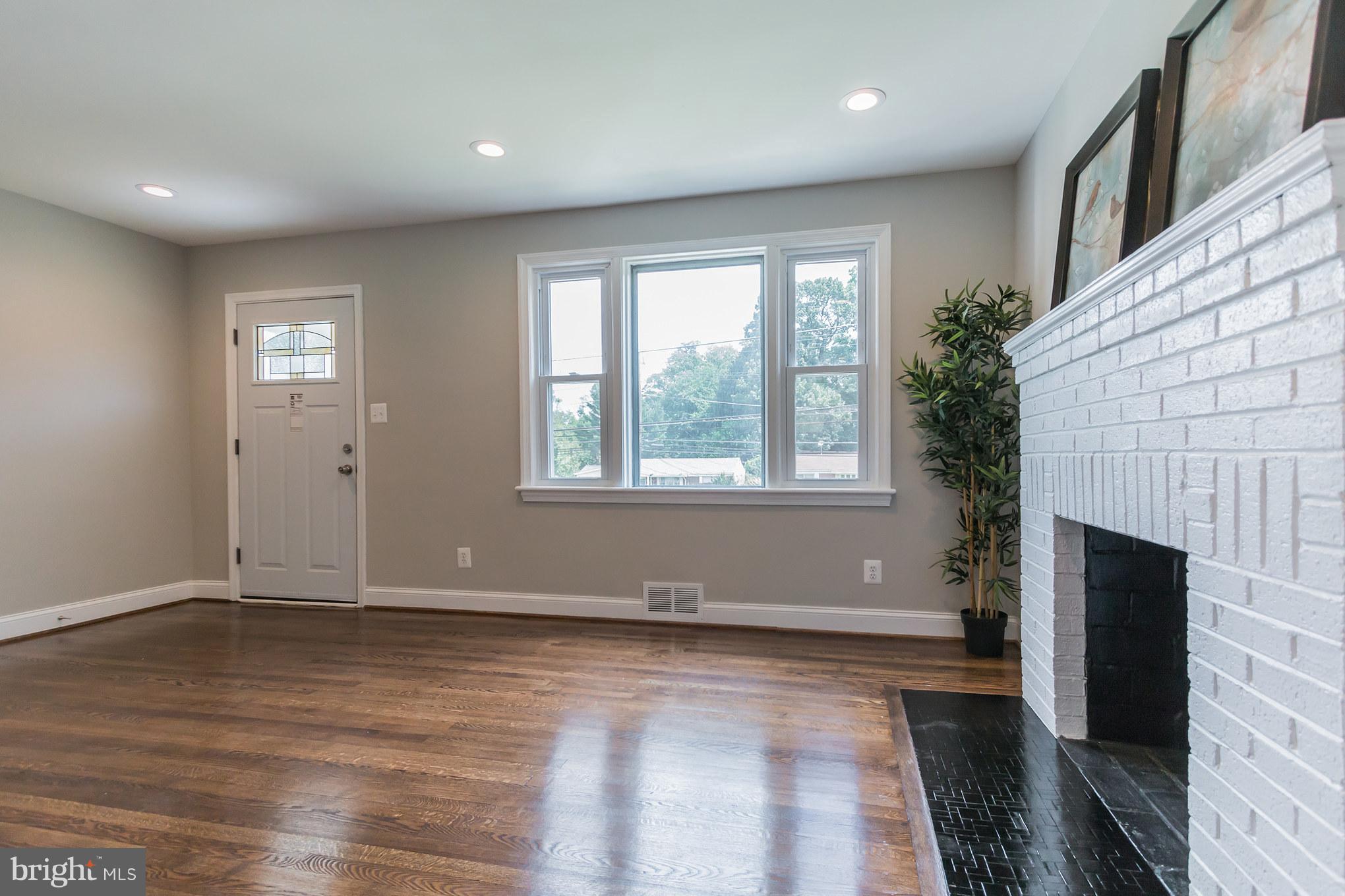 11508 Veirs Mill Road Silver Spring, MD 20902 - Photo 5 of 30 an empty room with wooden floor and windows