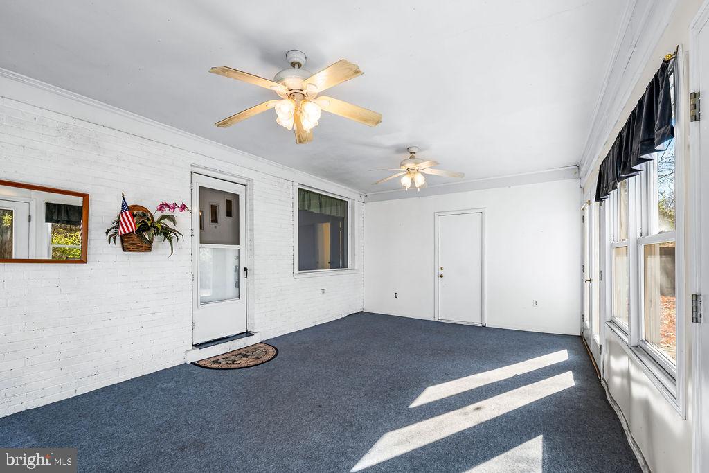 577 Brock Bridge Road Laurel, MD 20724 - Photo 26 of 41 a view of a livingroom with wooden floor and a ceiling fan