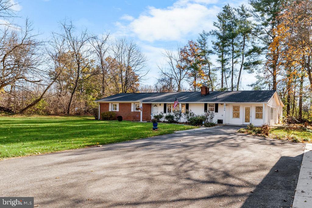 577 Brock Bridge Road Laurel, MD 20724 - Photo 29 of 41 a front view of a house with a garden