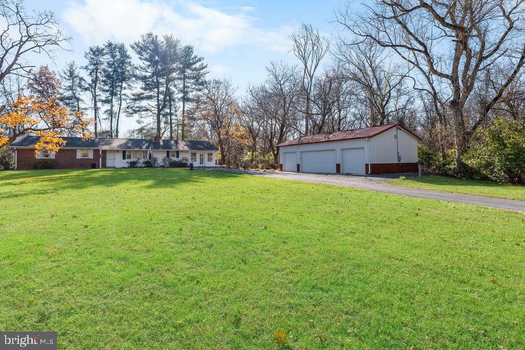 577 Brock Bridge Road Laurel, MD 20724 - Photo 3 of 41 a view of a tree in front of a house with a yard